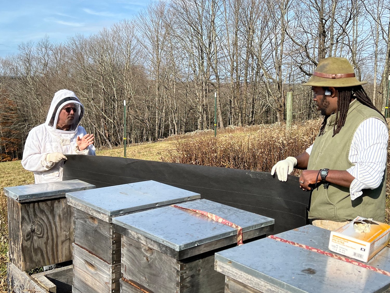 The unsung labor of beekeeping. Here, Art Riegal and a student do fall-related chores.